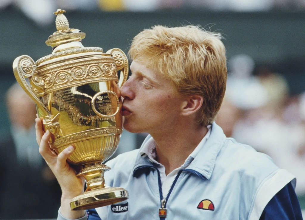 Boris Becker kisses the Wimbledon trophy after winning the tournament at age 17 in 1985.